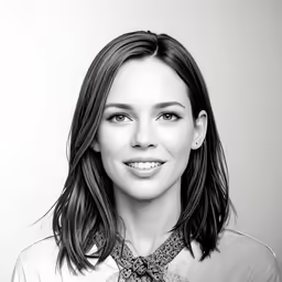 a women who is smiling with an unfocused look