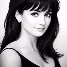 a young woman with long black hair wearing a tiara and big white earrings