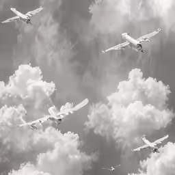 the group of airplanes are flying together high in the clouds