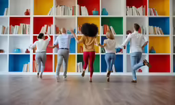 three women are dancing around a colorful book case