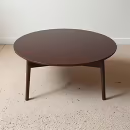a wooden table sitting on a carpeted floor