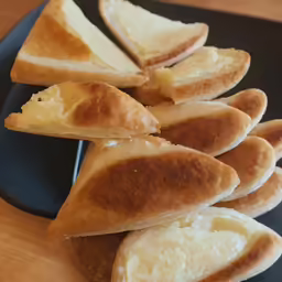a plate with several baked bread items arranged on it