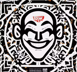 an illustrated poster in arabic with a creepy clown face,an oriental mask in the center of a circle of ornamental symbols