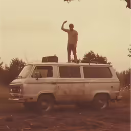 a man is standing on top of an old van