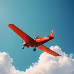 red single engine airplane flying above the clouds
