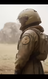 a man wearing a fighter uniform while standing on a desert