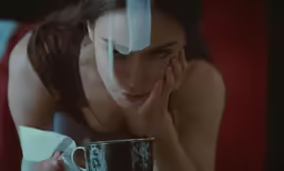 a woman in a white dress is holding a mug