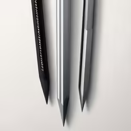 two pens sit next to each other on the wall