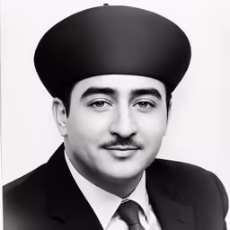 man in suit and tie with a black hat