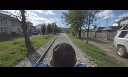 the boy is riding the rail to the train station