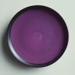 a bowl with a purple liquid in the middle