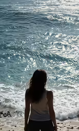 a person that is sitting in the sand