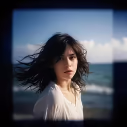 a woman with her hair blowing in the wind