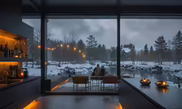 two people are sitting at a table in a room with a view