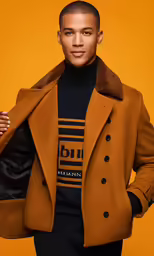 a man wearing an oversized coat and black turtle neck