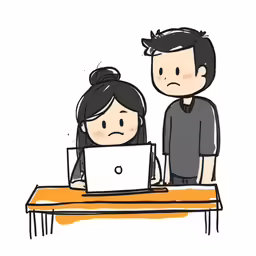 a man and woman in front of a laptop