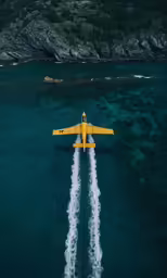 a small plane in flight over the ocean