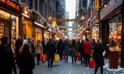 a crowd of people walk along an alley covered with shops