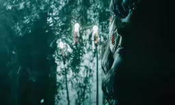 a woman standing outside by a window and looking at something