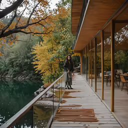 a woman standing on a wooden dock next to water