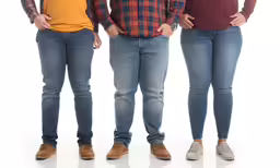 five people stand in a line with their hands on their hips