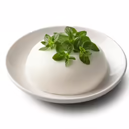 green leaves on top of a white bowl