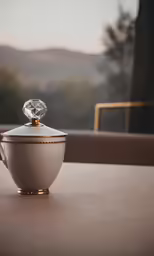 a bowl with a lid sitting on top of a table