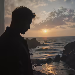 a man is looking at the camera on the beach