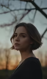 woman staring away at the sky during sunset