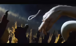 a person reaching to a snake in the dark