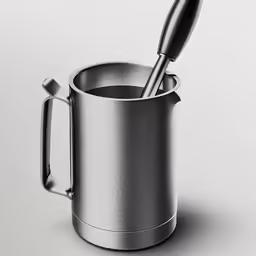 a silver cup that has a spoon inside of it