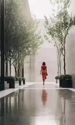 a woman in an orange dress walks down the aisle of a building