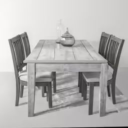 black and white photograph of table, chairs, vase, and fruit
