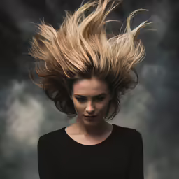 woman with hair blowing up, from front