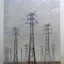 a photograph of electrical towers and wires