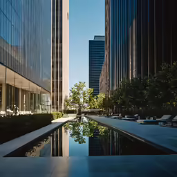 a pool in front of a large building with buildings behind it