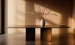 a vase with dry plants in it next to a large window