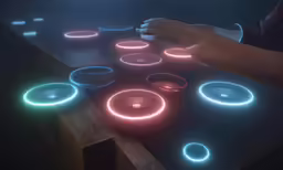 a woman using a remote control to change colored circles