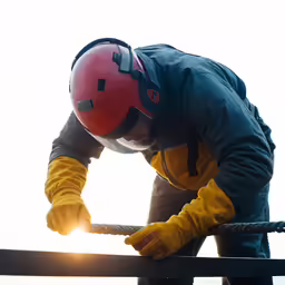 a man standing on top of a ship wearing a helmet and holding onto the ropes