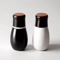 two different vases next to each other on a white table