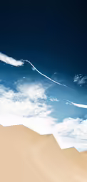 a lone airplane flying through the sky above sand dunes