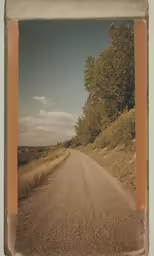 there is a small square photo taken in front of an image of a road