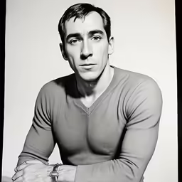 an old black and white photo of a man in sweater