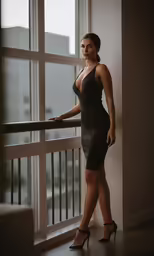 a woman standing in front of a window
