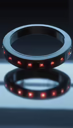 a ring with glowing red lights set up against a reflective background