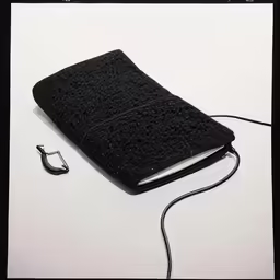 an old book and usb cord in front of a white background