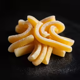 closeup of pieces of thin pastry sitting on a black background