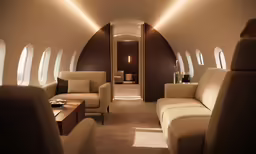 a living area with large windows in an airplane