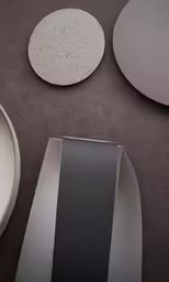three plates sitting on top of a black surface