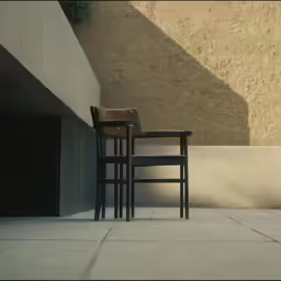 two chairs and a table against a stucco wall